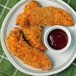 Air Fryer Chicken tenders on a plate with BBQ sauce