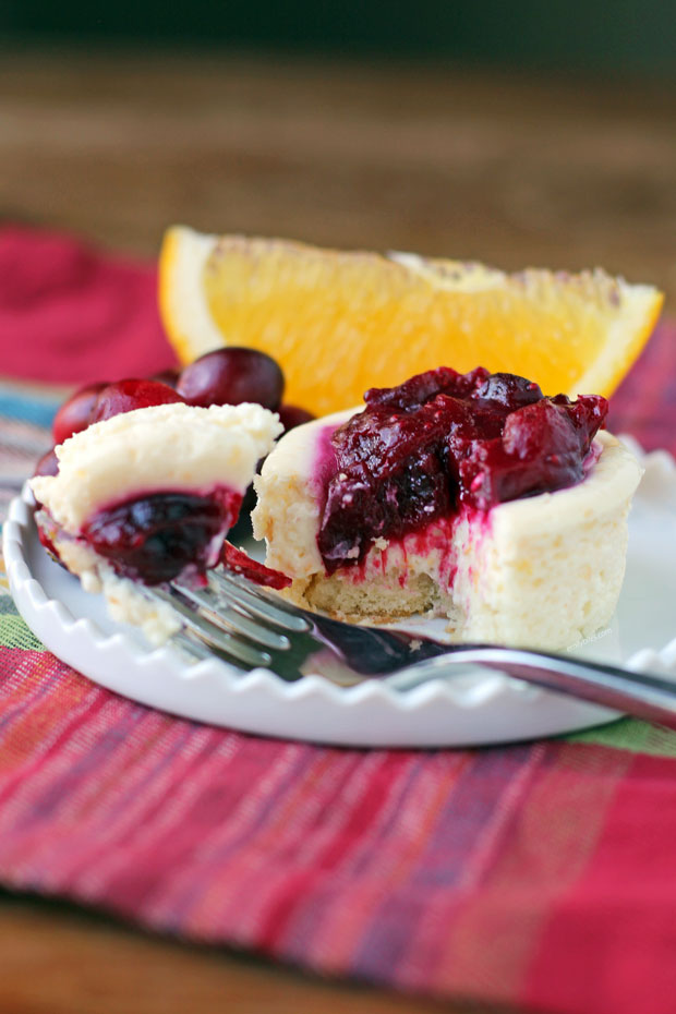 Orange Cranberry Cheesecake Cup with a bite on a fork
