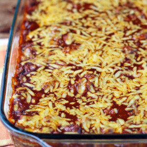 Layered Meat and Bean Enchilada Bake in a dish