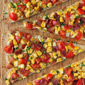 Bacon, Corn and Tomato Flatbread close up on cutting board