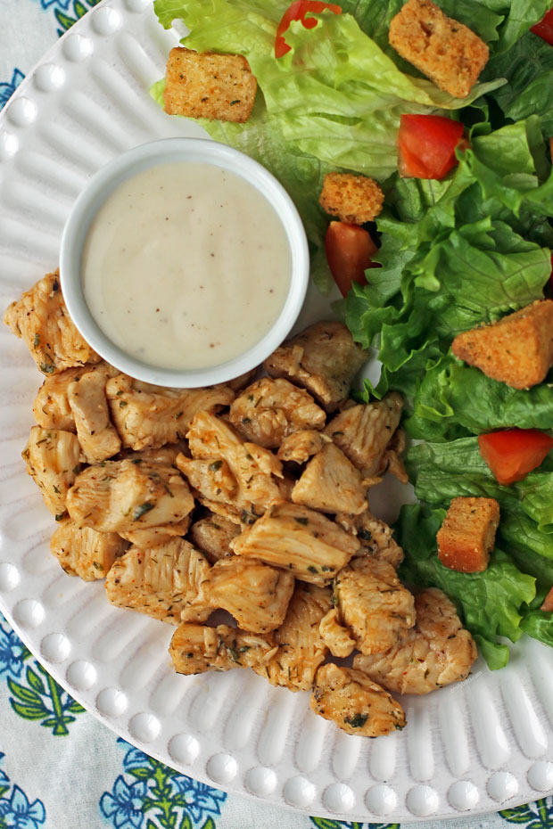 Pickle Brined Chicken Bites plated with salad