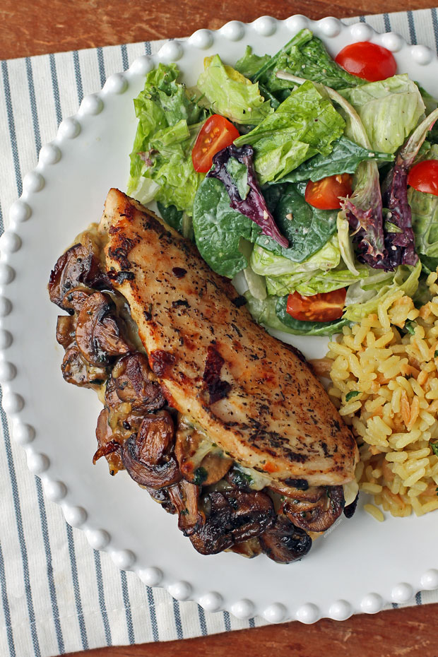 Mushroom and Mozzarella Stuffed Chicken plated with salad and rice