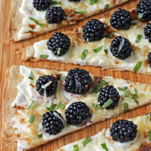 Blackberry Ricotta Flatbread sliced on a cutting board
