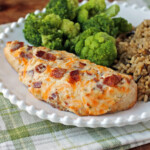 Cheesy Bacon Ranch Baked Chicken plated with broccoli and rice