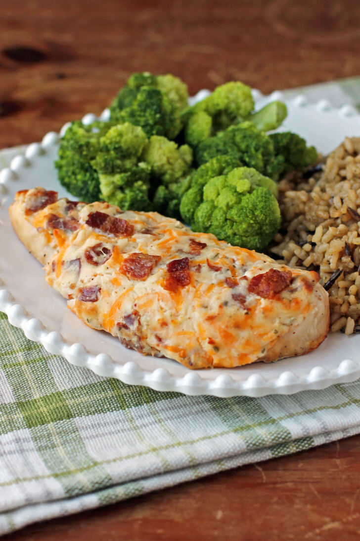 Cheesy Bacon Ranch Baked Chicken plated with broccoli and rice