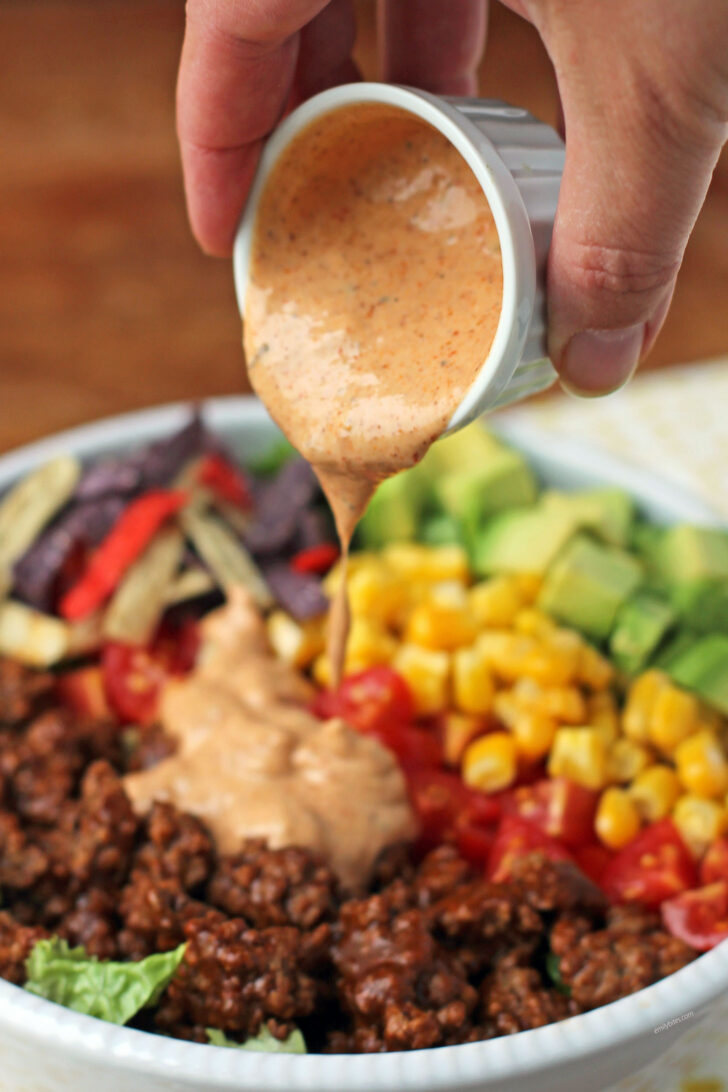 Beef Taco Salad with Salsa-Ranch Dressing pouring on top