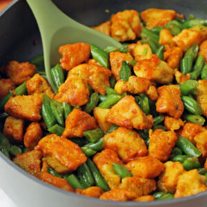 Honey Turmeric Chicken and Green Bean Skillet stirred in pan