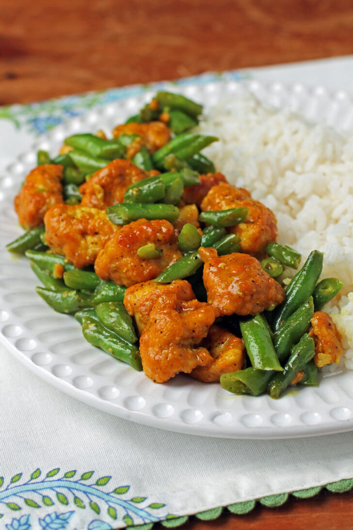 Honey Turmeric Chicken and Green Bean Skillet plated with rice