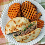 Quesadilla Burger with fries on a plate