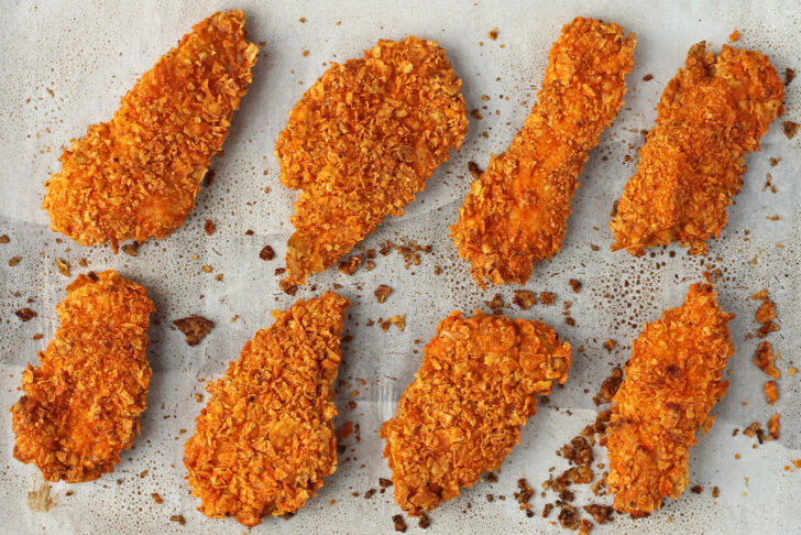 Doritos-Crusted Chicken Tenders on a baking sheet
