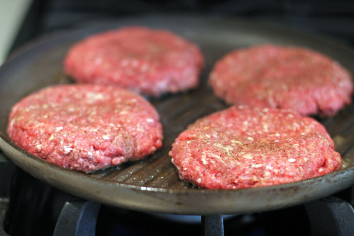 Stuffed Pizza Burgers cooking on the stovetop