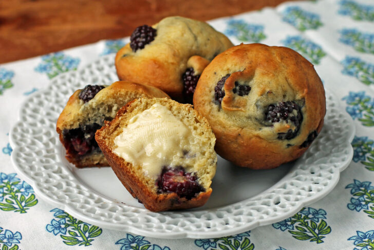Blackberry Vanilla Muffins on a plate with butter