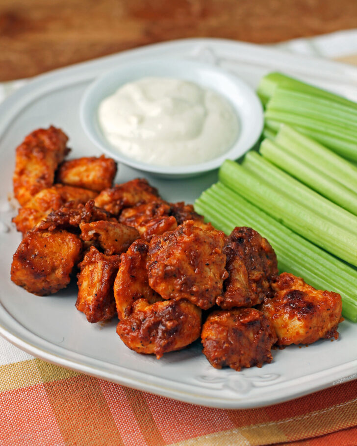 Spicy Buffalo Chicken Bites plated with celery and blue cheese