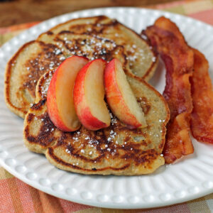 Peach Oatmeal Pancakes plated with bacon