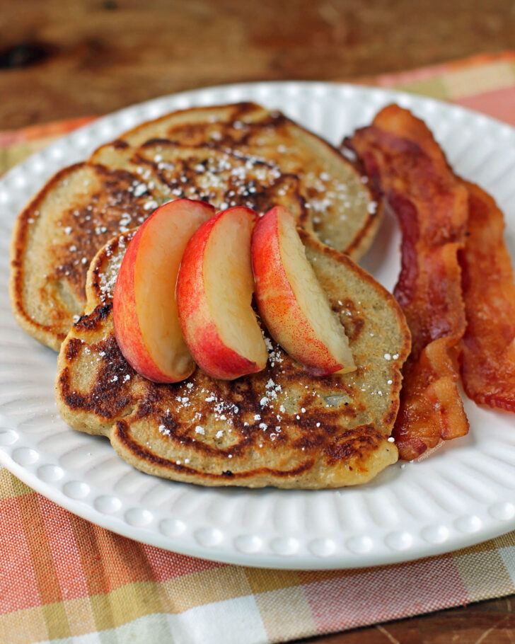 Peach Oatmeal Pancakes plated with bacon