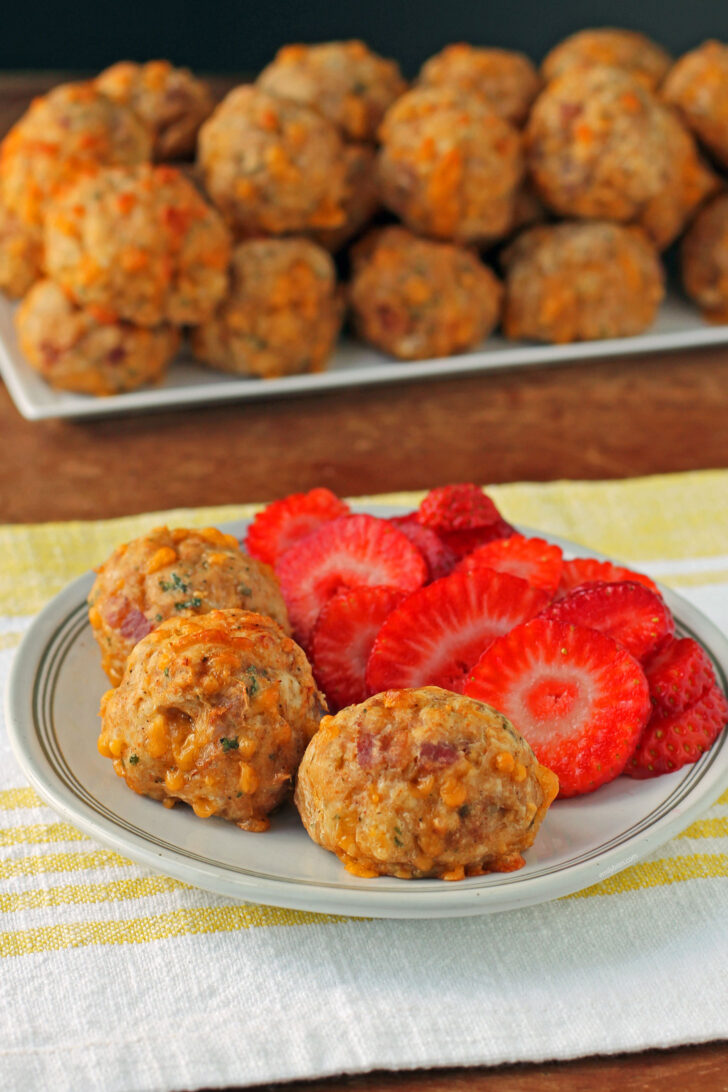 Maple Bacon Bisquick Sausage Balls plated with strawberries