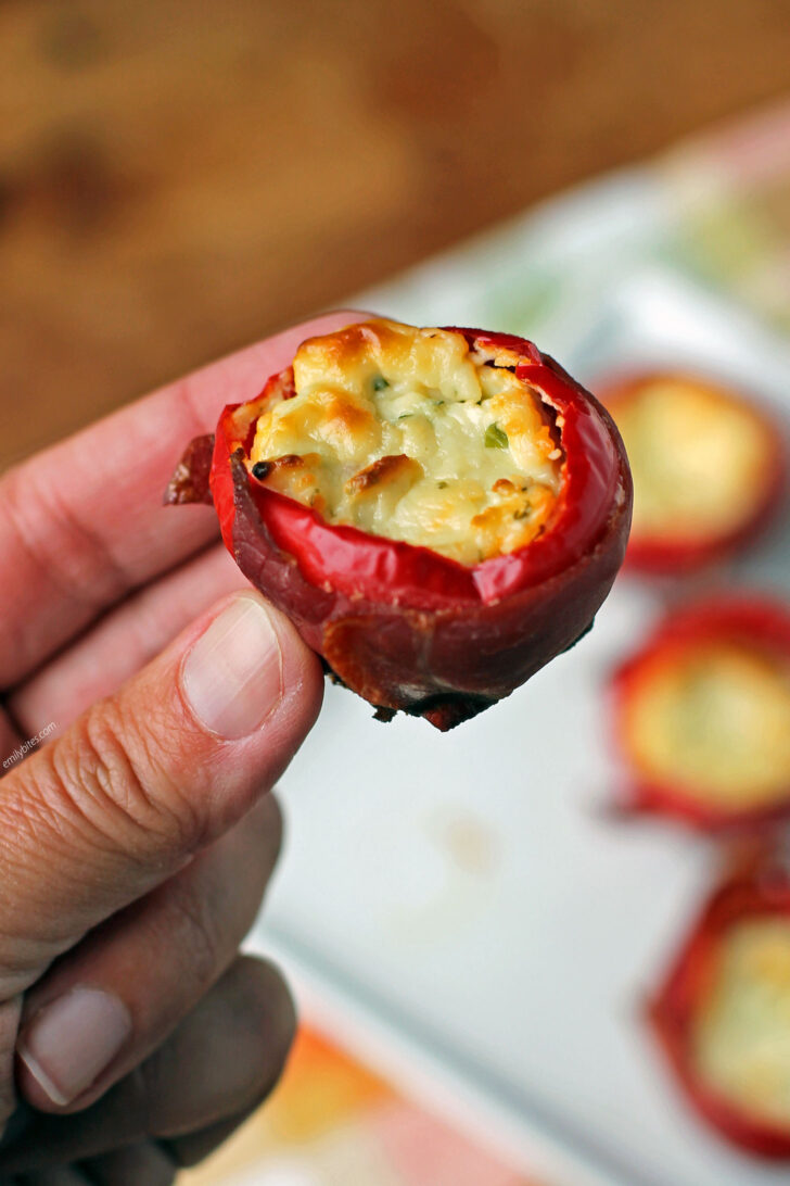 Prosciutto Wrapped Stuffed Cherry Pepper held in hand